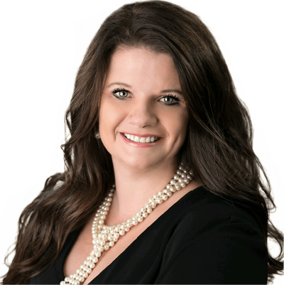 Mortgage lending team - Professional headshot of a woman with long dark hair wearing a black blazer and pearl necklace, smiling at the camera against a white background.