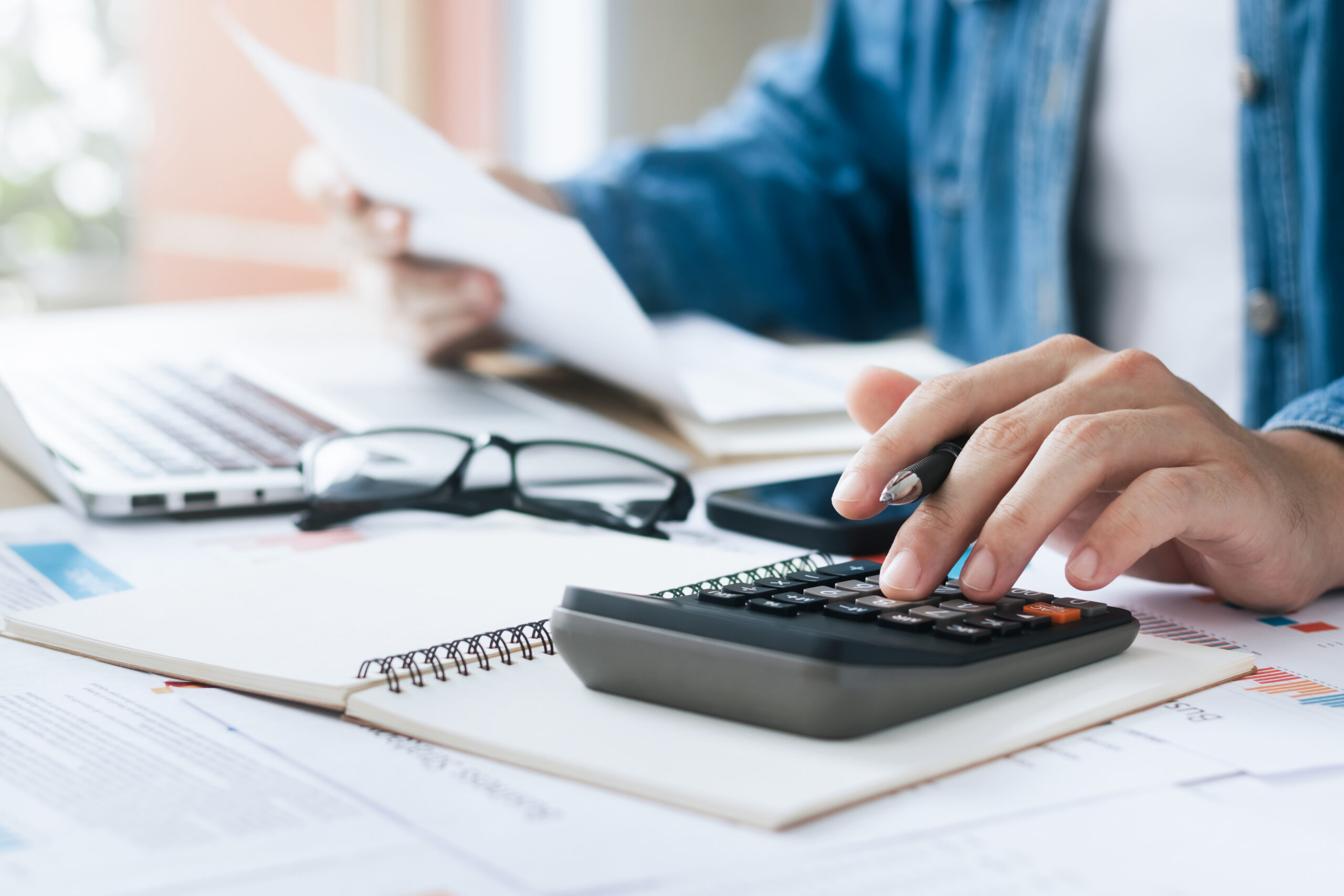 Basic checking page hero image - Investors are calculating profits and costs with calculators, growth and investment chart analysis, business planning and strategies to maximize sales profits. Long term business plan.