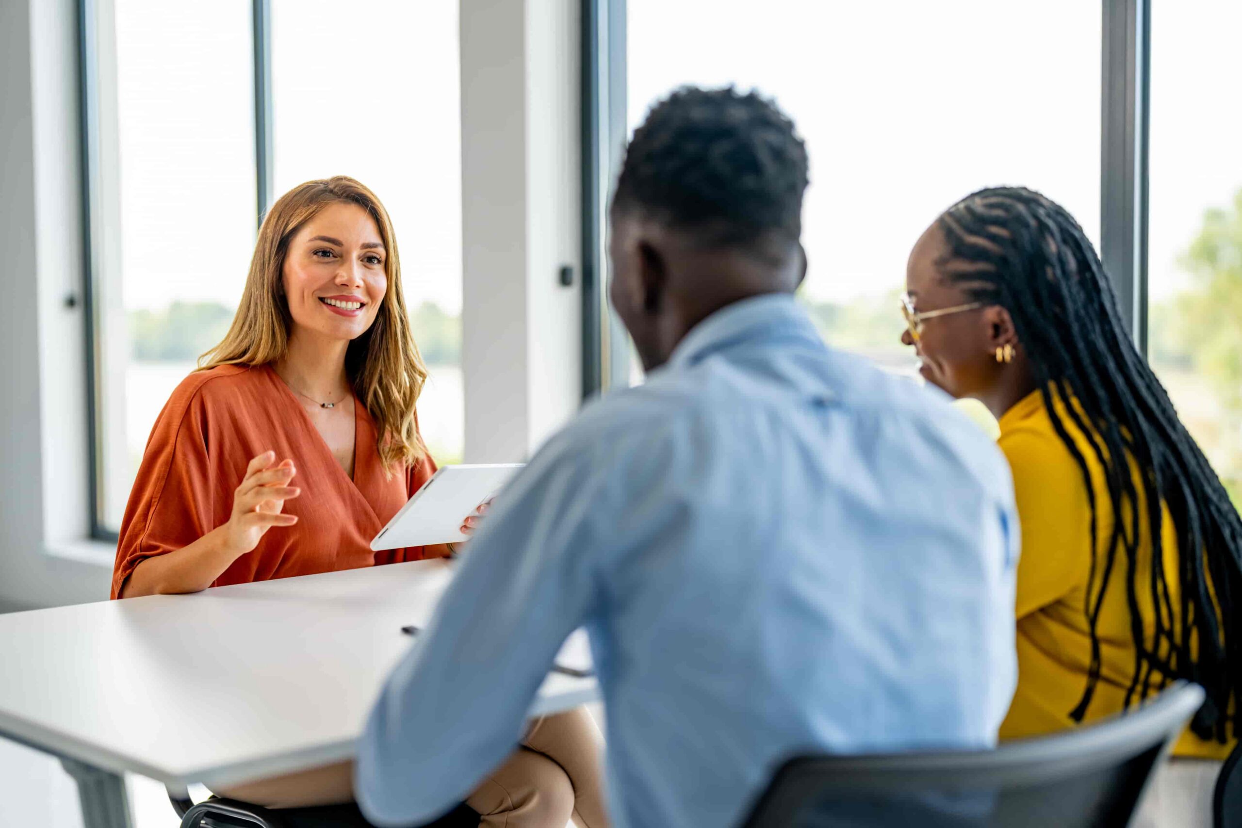 Banking advisor helping young African American couple open a new account