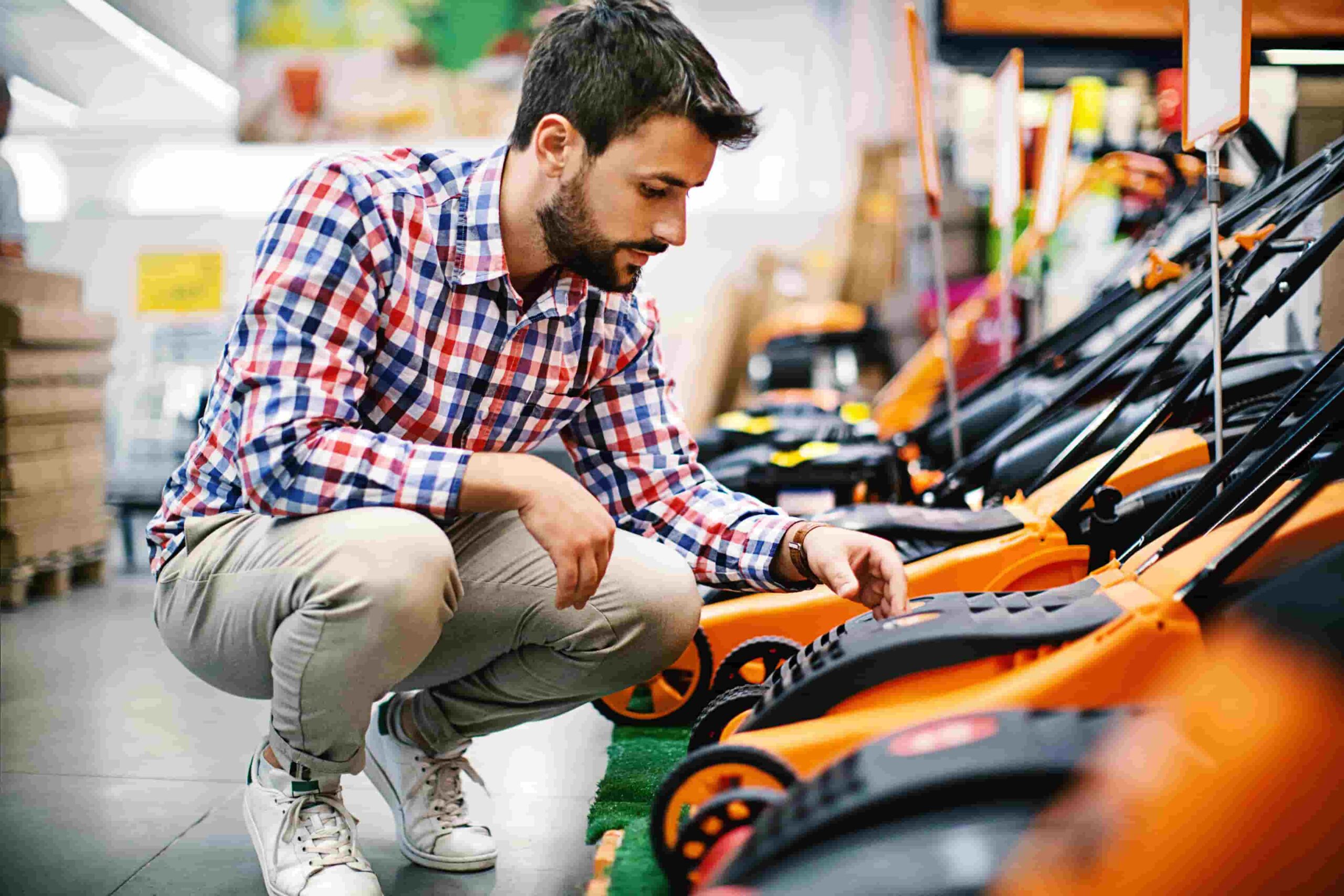 Buy now pay later - man looking at buying lawn mower
