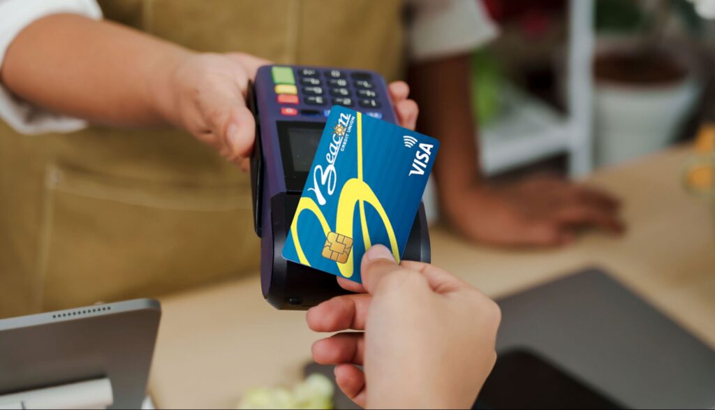 Beacon Credit Union Debit card being used at a terminal